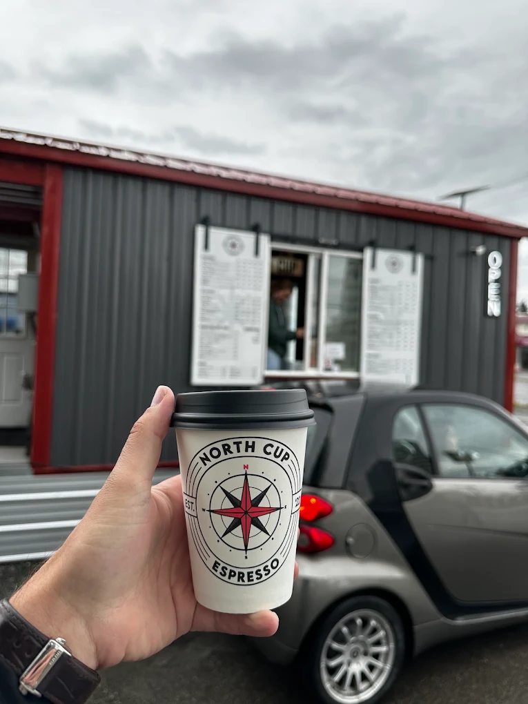 North Cup Espresso cup held in front of the drive-through stand